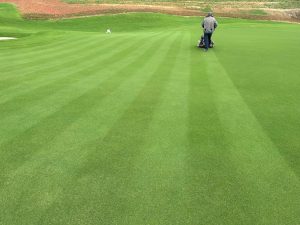 Greenkeeper on Mach 1 green at Montaña Golf Project, North Vietnam